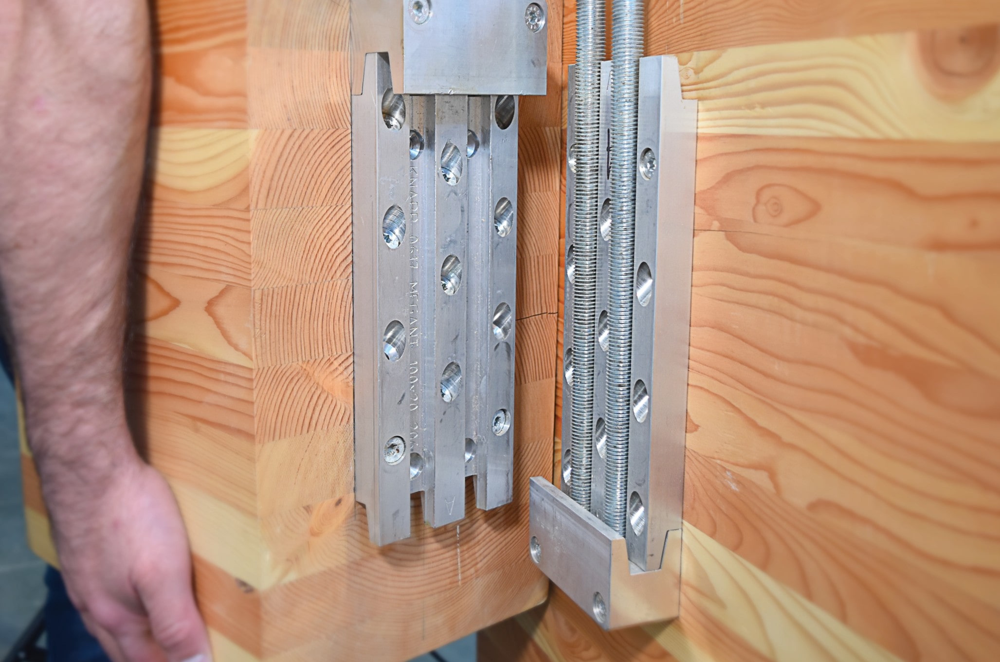 MEGANT beam hanger, a pre-engineered high-capacity mass timber post-to-beam connector that is pre-installable and installable from all directions, fully concealable for meeting fire resistance rating requirements, designed and tested for mass timber post-to-beam connections, and available in a large variety of sizes